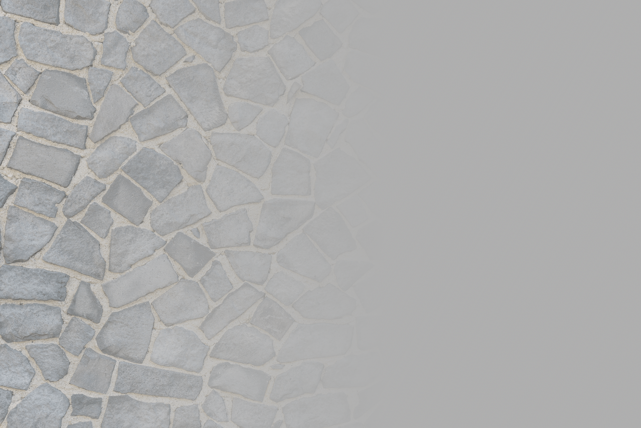 a background image of non-uniform tiles on the left half. The image fades to grey on the right half