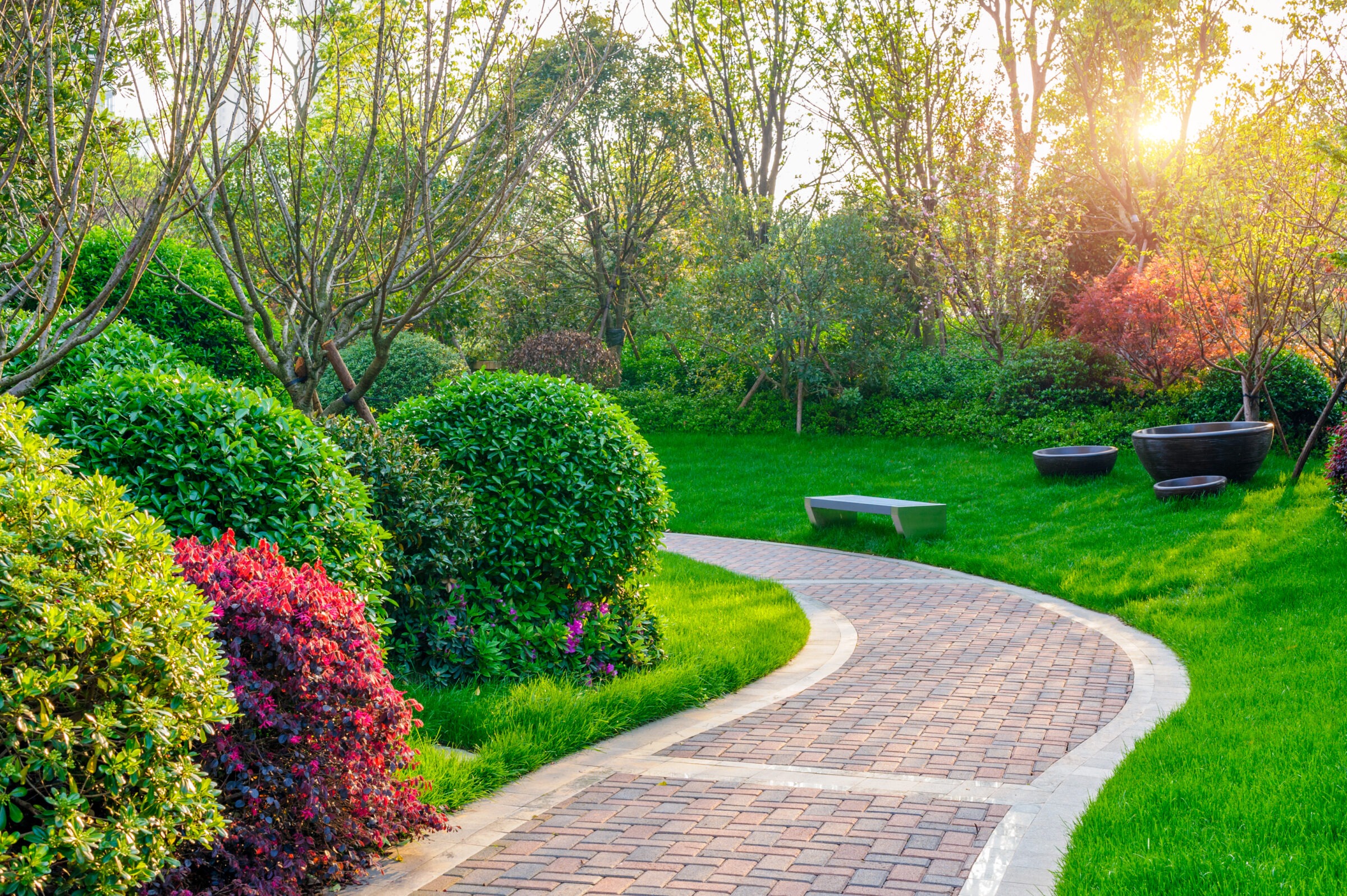 Low maintenance landscaping ideas using a beautiful custom brick path.