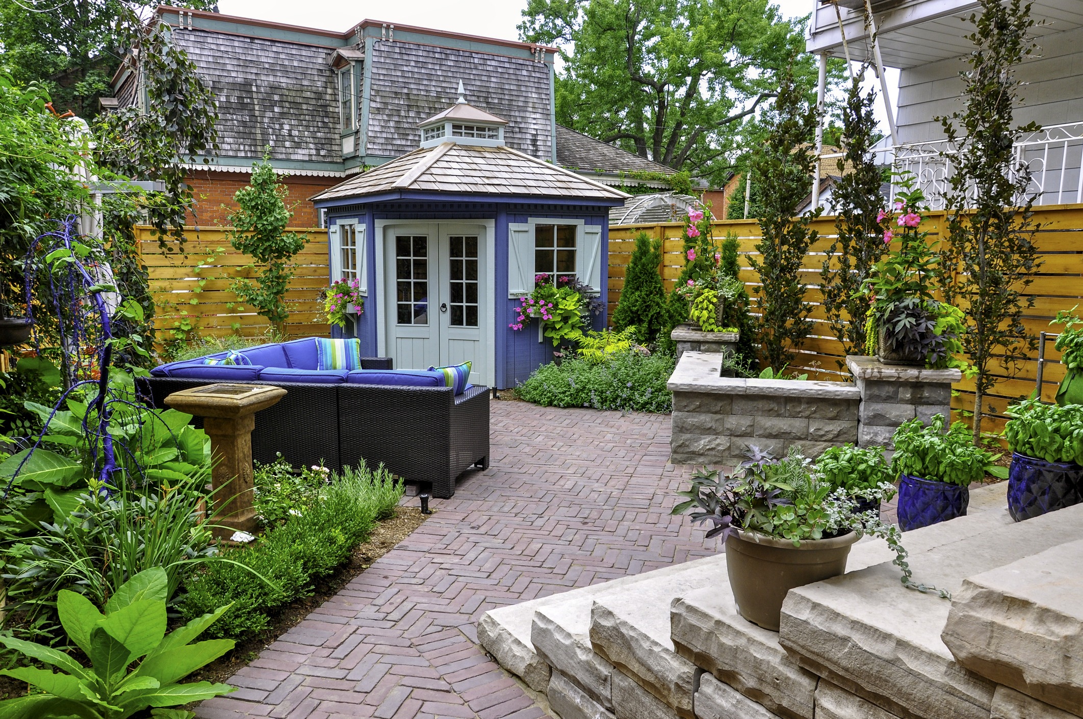 A beautiful outdoor space, this luxury landscaped backyard garden is a relaxing oasis.