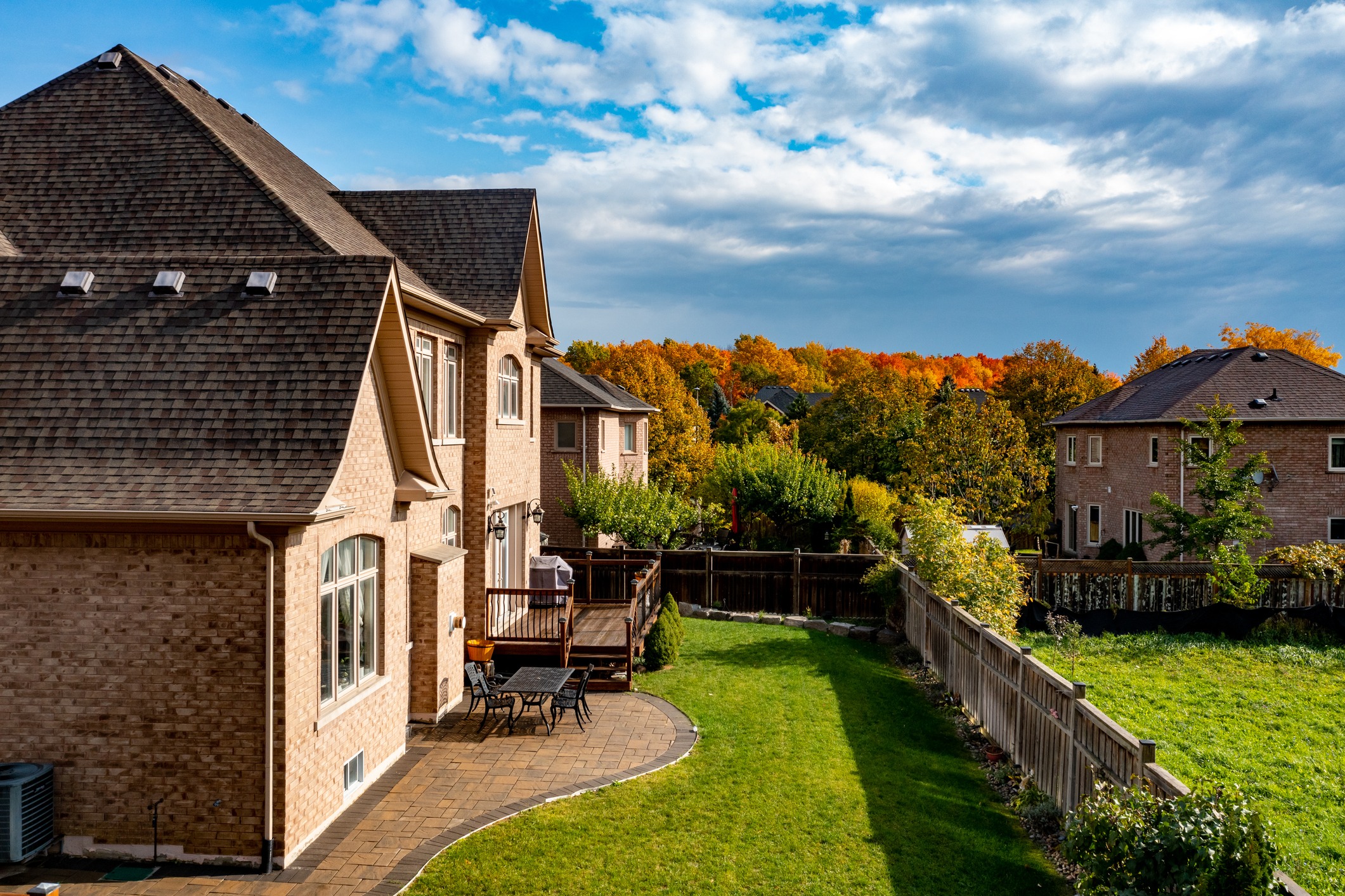 A backyard with a fall landscape in the background.