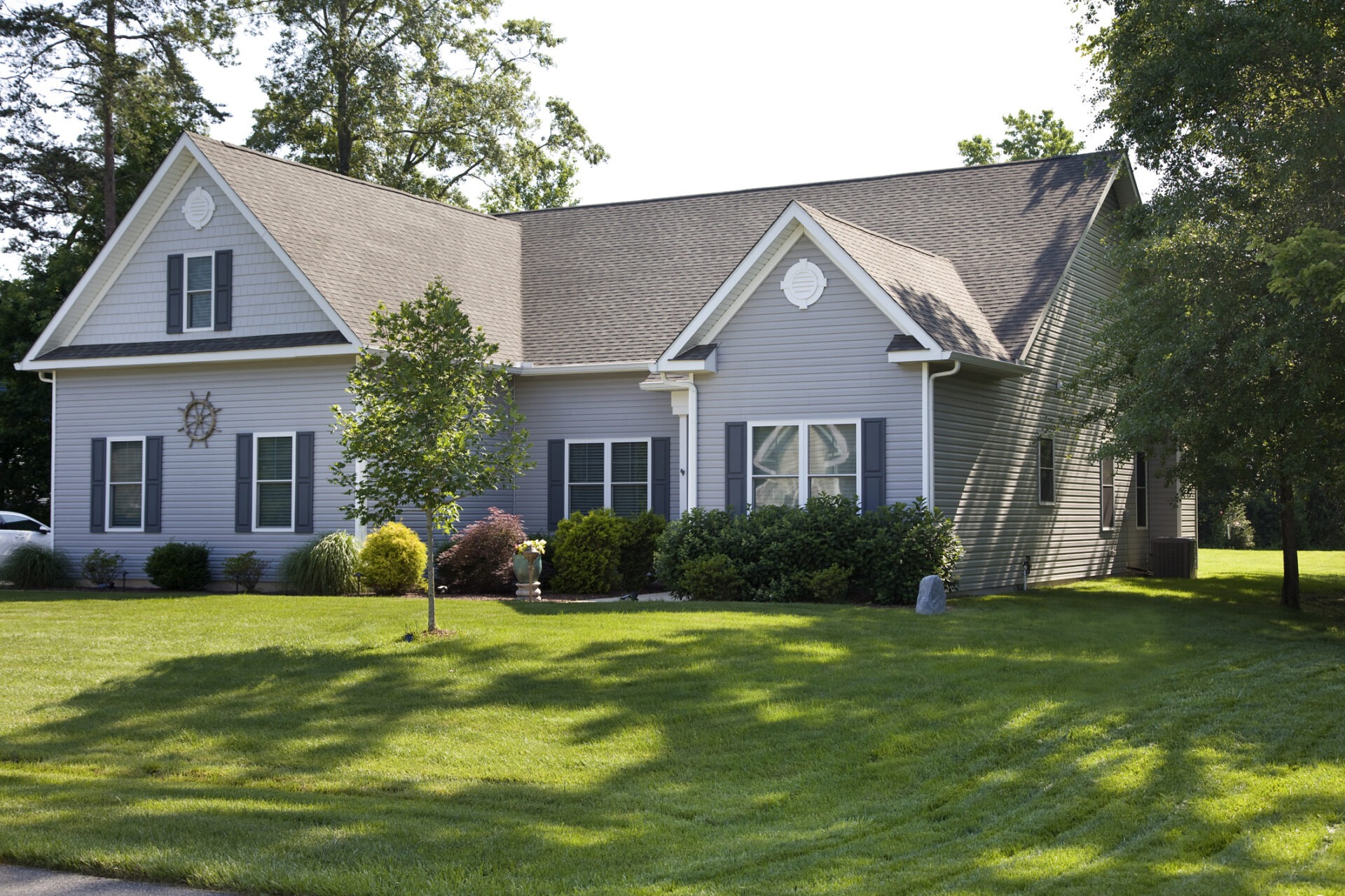 Front yard and suburban home with manicured lawn in the suburbs.