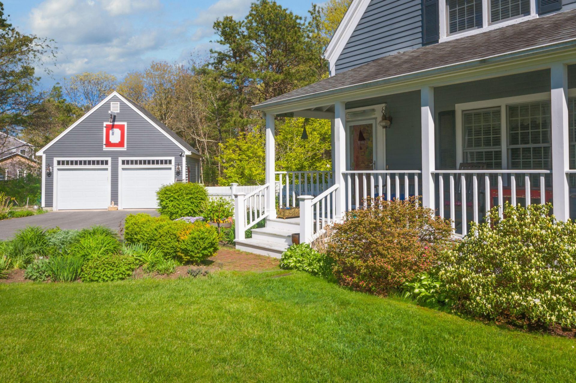 Front yard landscaping with lush lawn and planting beds in Massachusetts