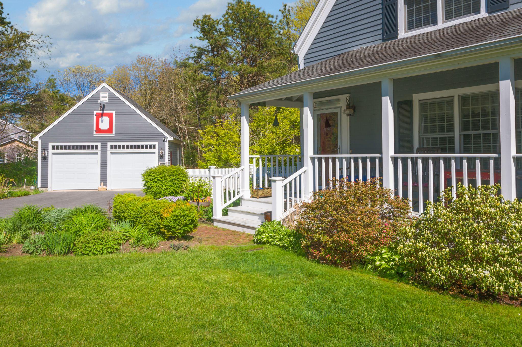 Front yard landscaping with lush lawn and planting beds in Massachusetts