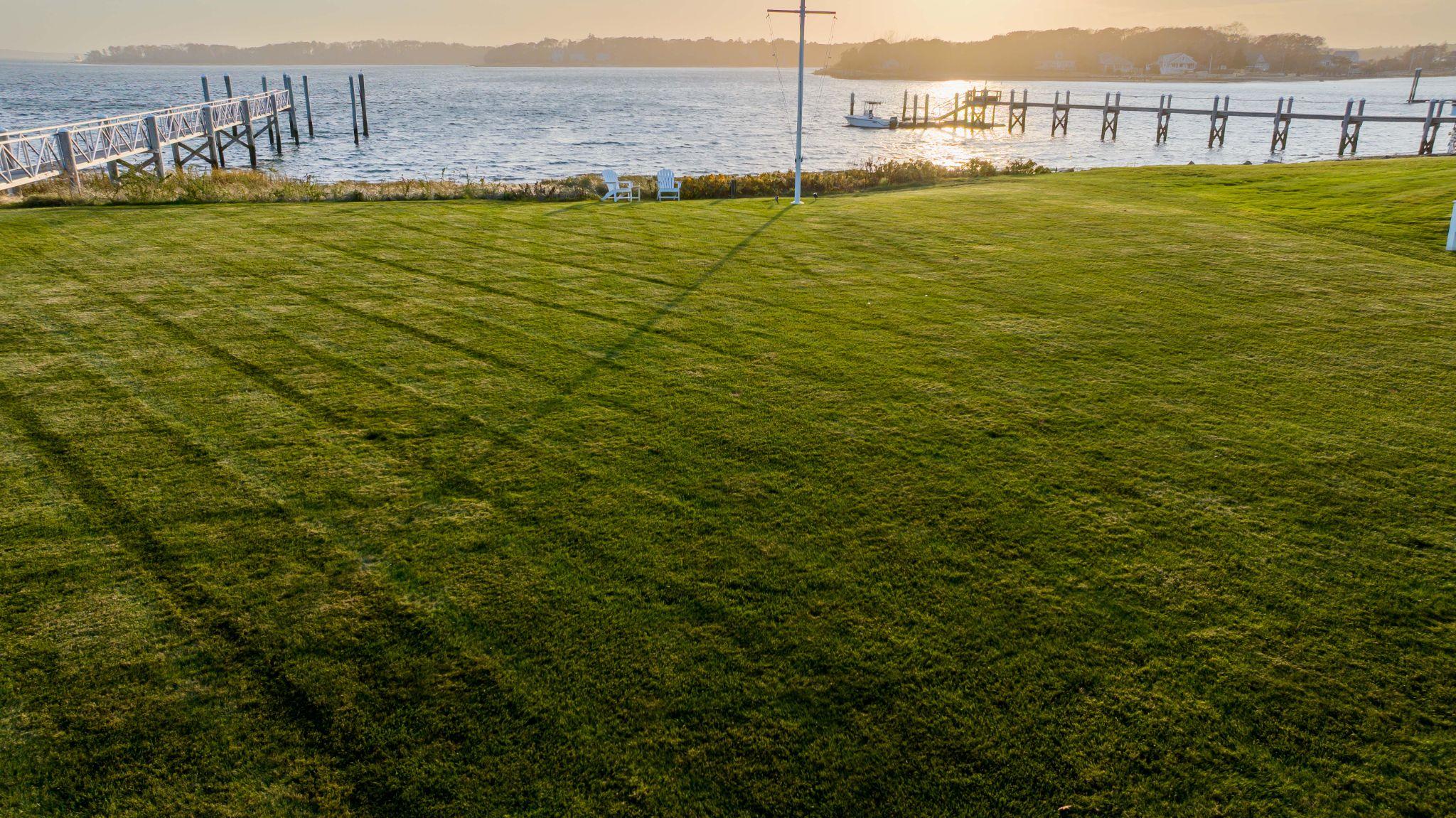 Large waterfront lawn with dock and healthy grass on the South Shore